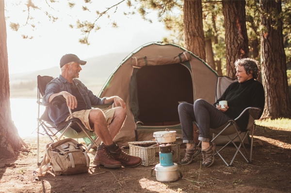 Camping-Preparedness A couple sitting beside camp fire