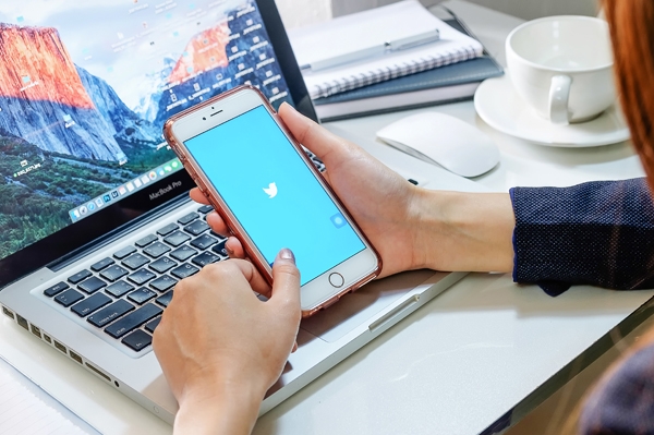 How to Save Lives in the Workplace Sitting at desk with cellphone